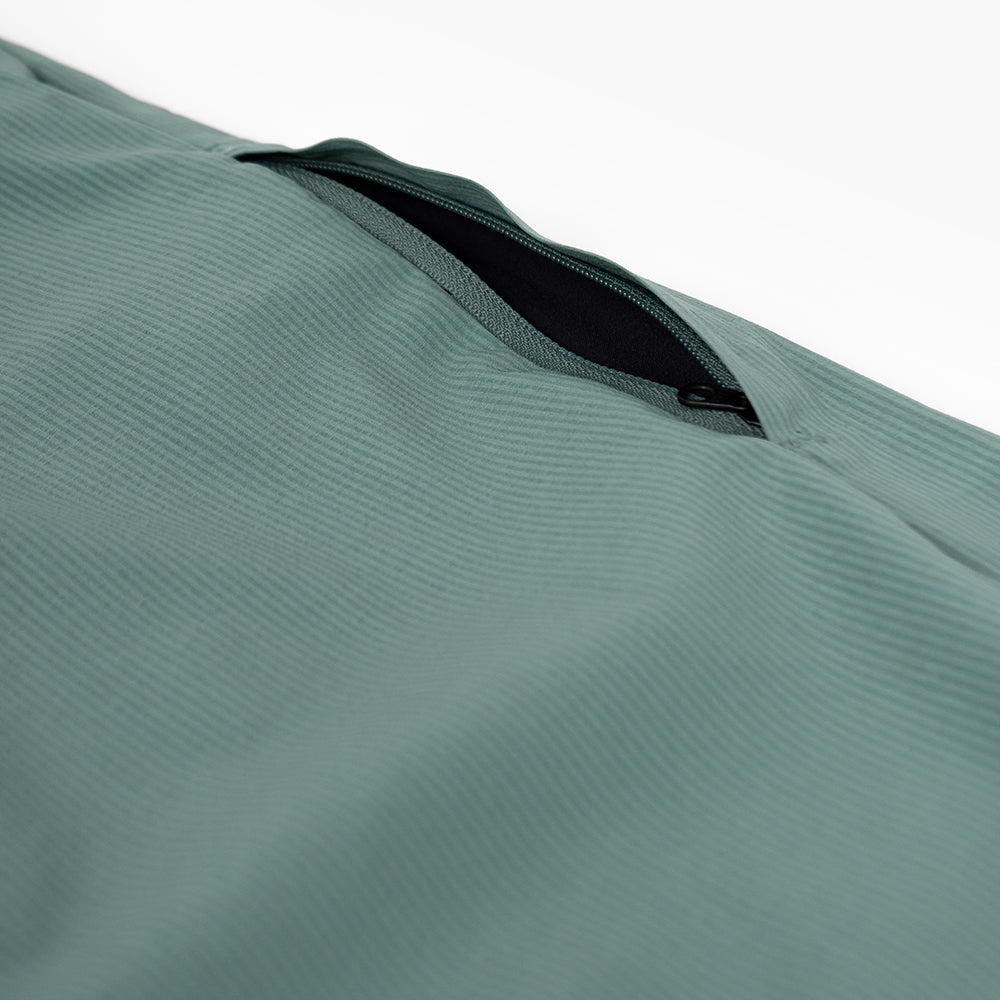 detail view of the zippered leg pocket of the ciele athletics CCPants unisex running pants from the Lifestyle Edition collection, in silver pine color