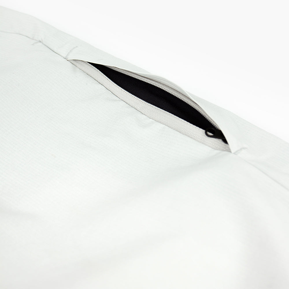 detail view of the leg zippered pocket of the ciele athletics CCPants unisex running pants from the Lifestyle Edition collection, in light grey color