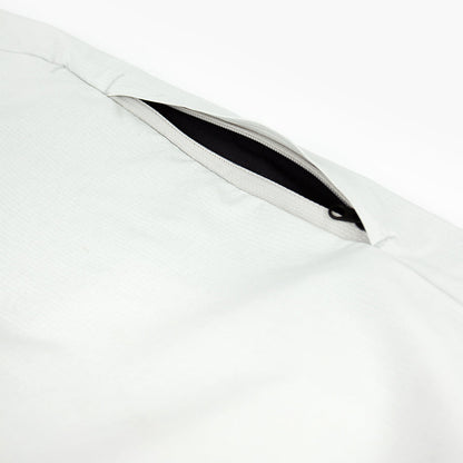 detail view of the leg zippered pocket of the ciele athletics CCPants unisex running pants from the Lifestyle Edition collection, in light grey color