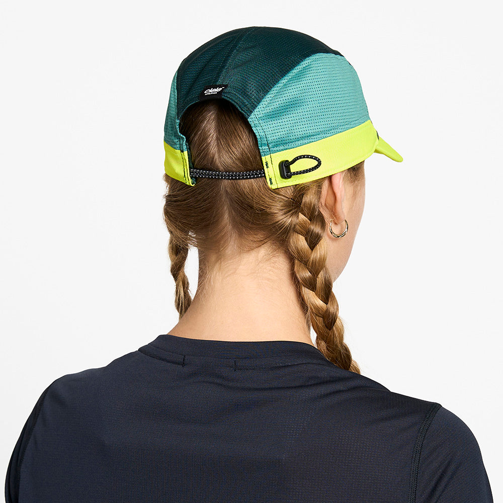 back view of the ciele athletics FTSCap unisex running hat in seaweed color, on a model