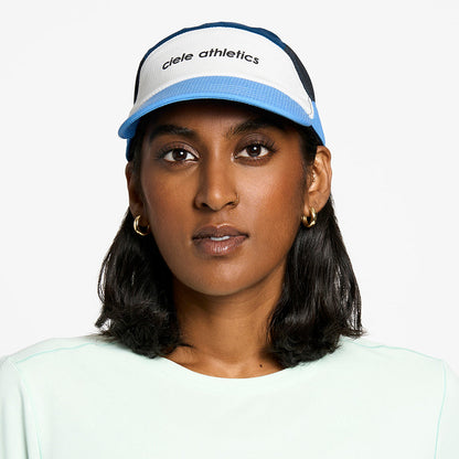 front view of the ciele athletics FTSCap unisex running hat in white cobalt color, on a model