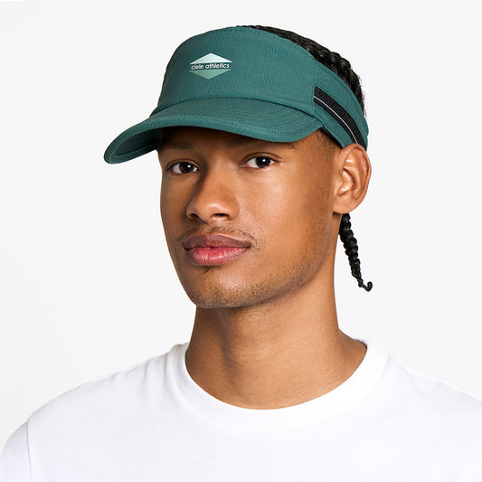 front view of the ciele athletics TRLCap unisex running visor with a curved brim in emerald color, on a model