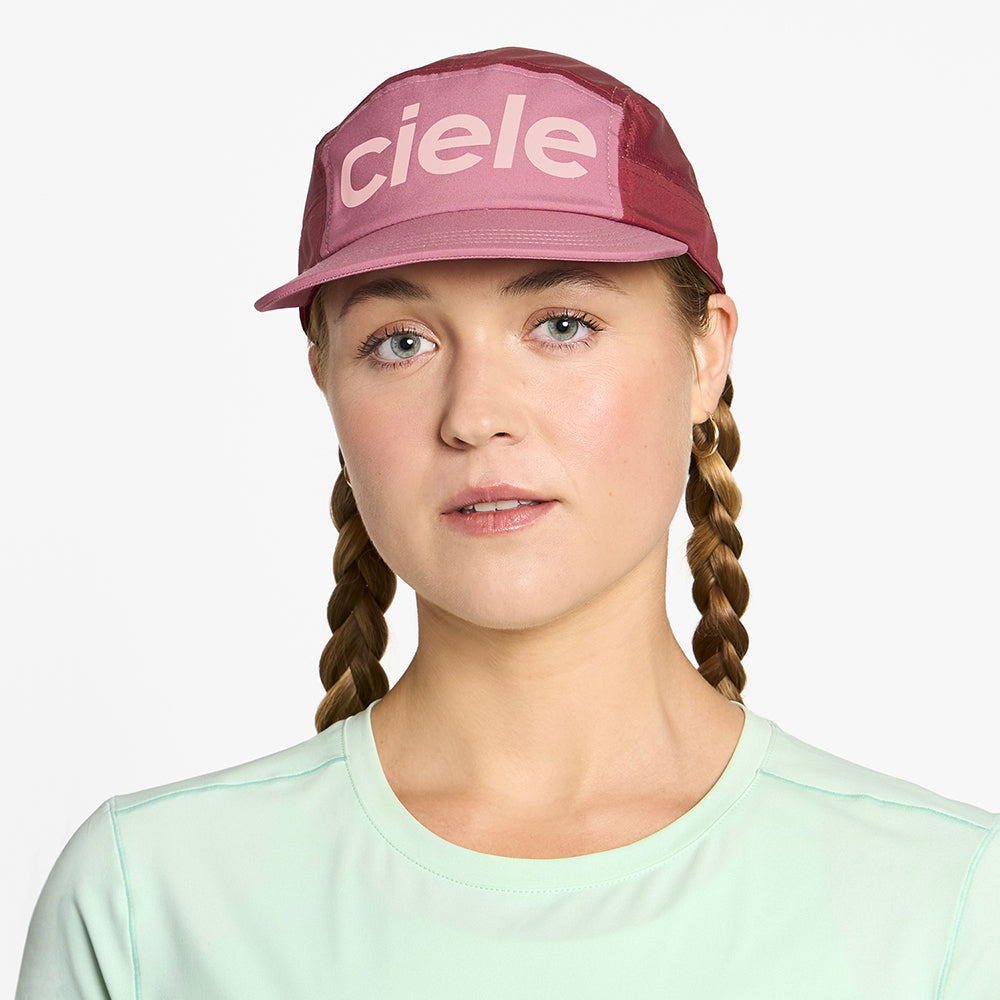 front view of ciele athletics GOCap Comp Century unisex running hat in deco rose merlot color on a model