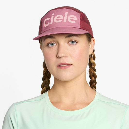 front view of ciele athletics GOCap Comp Century unisex running hat in deco rose merlot color on a model