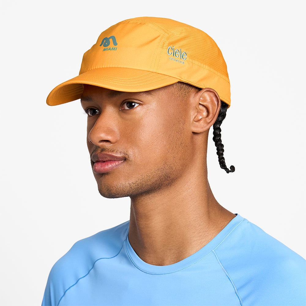 side view of ciele athletics GOCap SC Comp Word Wild Mouvement unisex running hat for the Miami marathon on a model
