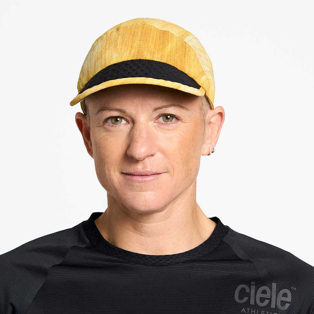 front view of ciele athletics FSTCap unisex running hat from the Elite collection in sphinx color, on a model