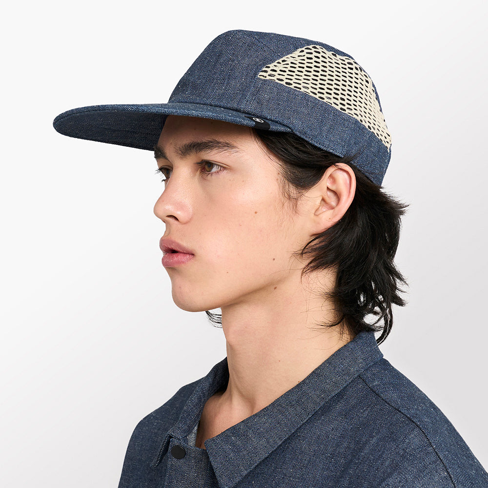 side view of ciele athletics GOCap longbrim unisex running hat with longer brim from the Lifestyle Edition collection, in denim indigo color, on a model