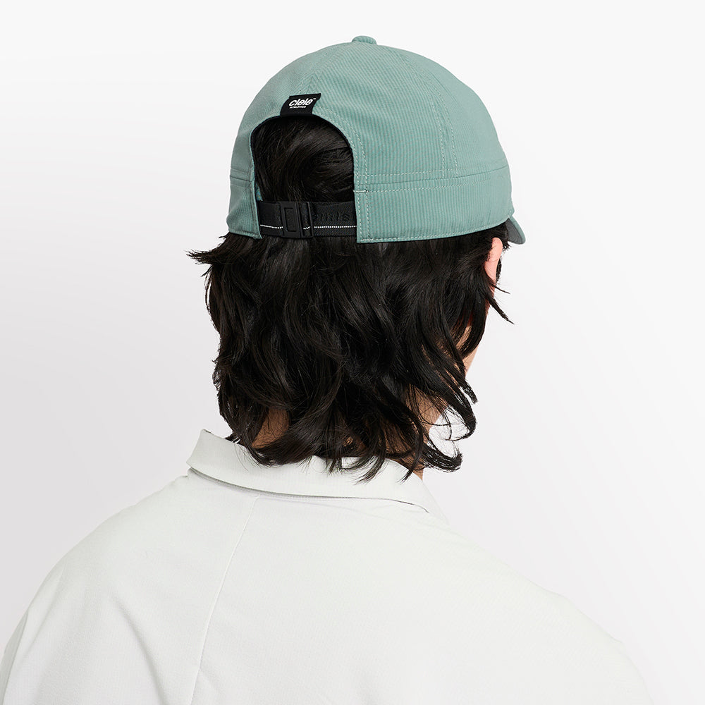 back view of ciele athletics CRWCap short brim unisex running hat with shorter brim from the Lifestyle Edition collection, in silver pine color, on a model