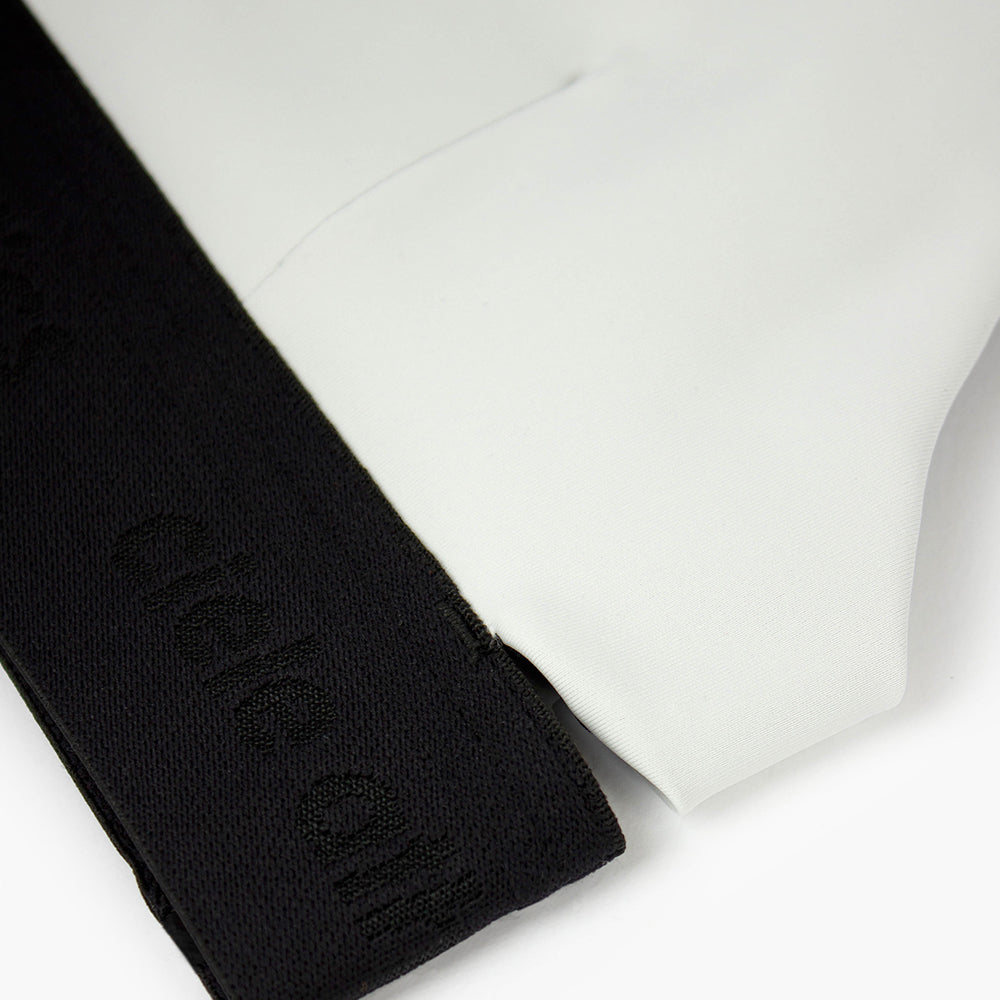 close view of the elastic and fabric of the ciele athletics QCKBra running bra in light grey