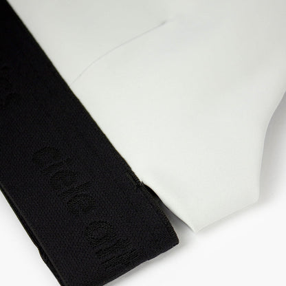 close view of the elastic and fabric of the ciele athletics QCKBra running bra in light grey