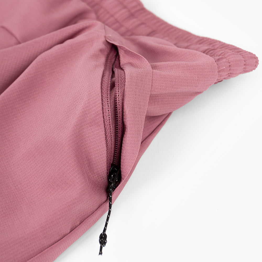 close view of the zippered side pocket of the ciele athletics ATShort 4 inch with liner short in deco rose color