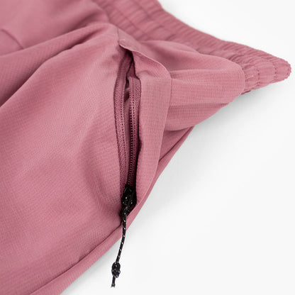close view of the zippered side pocket of the ciele athletics ATShort 4 inch with liner short in deco rose color