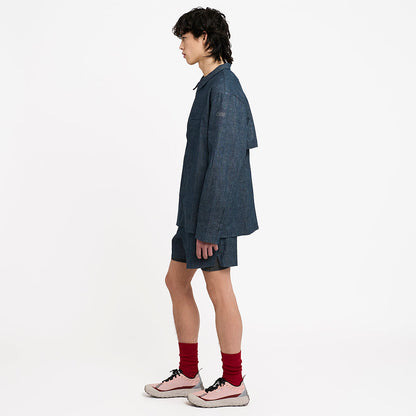 side view of ciele athletics CCJacket unisex running jacket from the Lifestyle Edition collection, in denim indigo color, when worn with the CCShort in Denim Indigo
